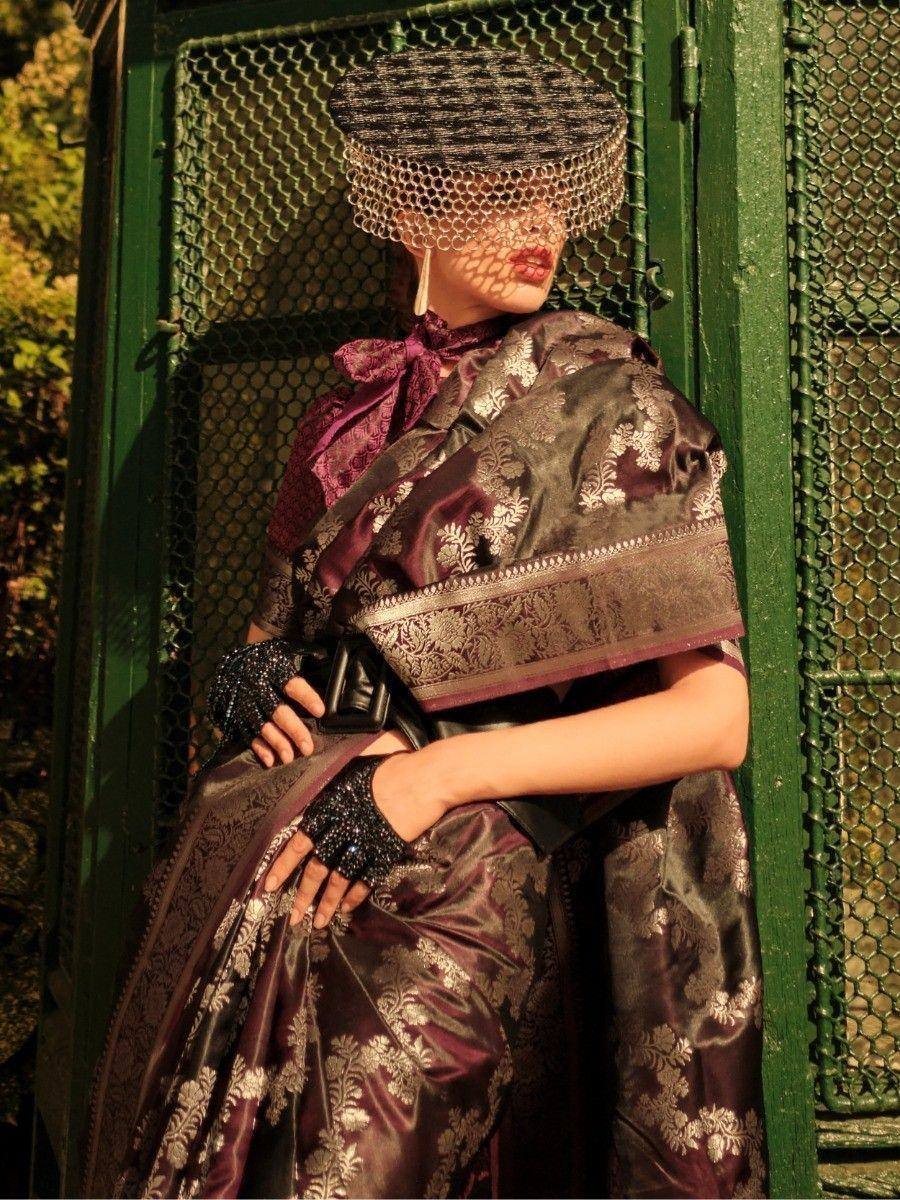 Elegant maroon and gold ethnic gown with intricate floral embroidery, paired with a mesh veil and statement gloves.
