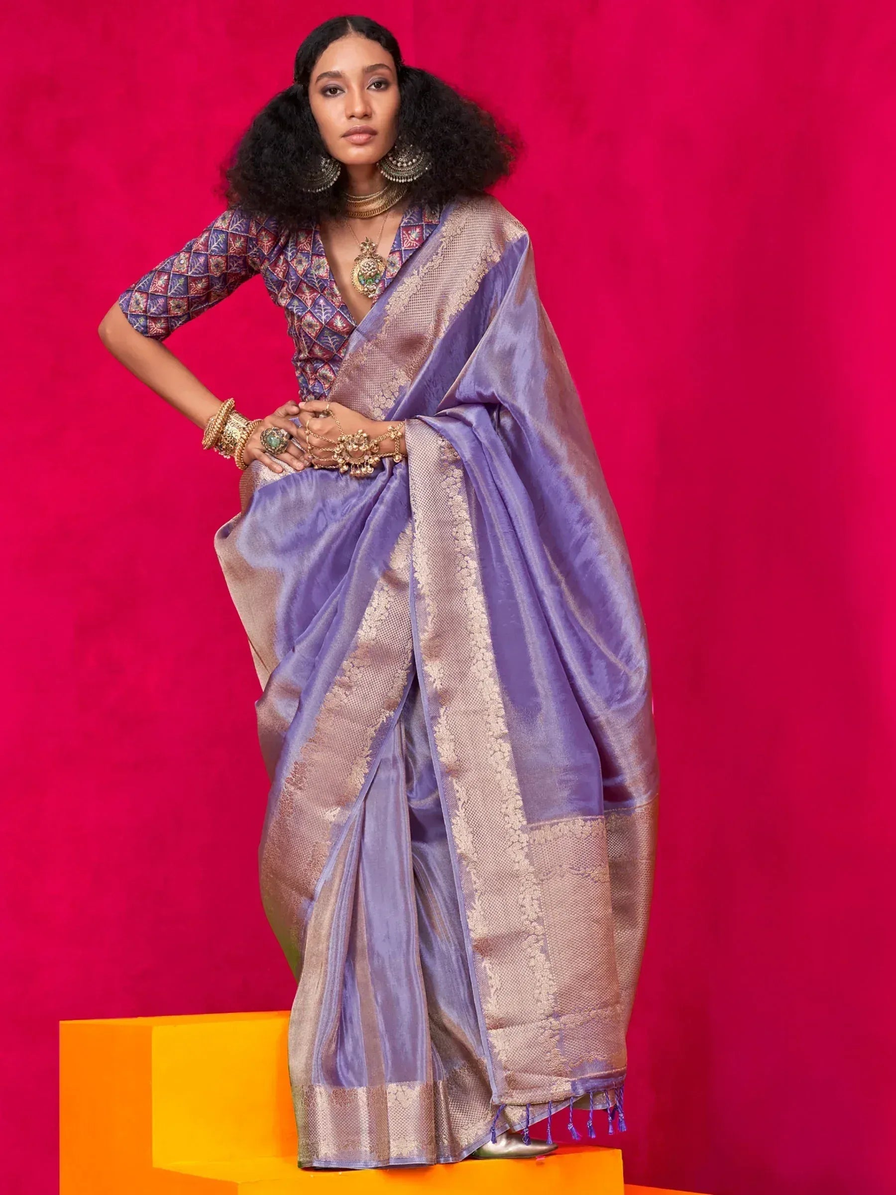 Purple silk saree with gold border, paired with embroidered blouse and traditional jewelry