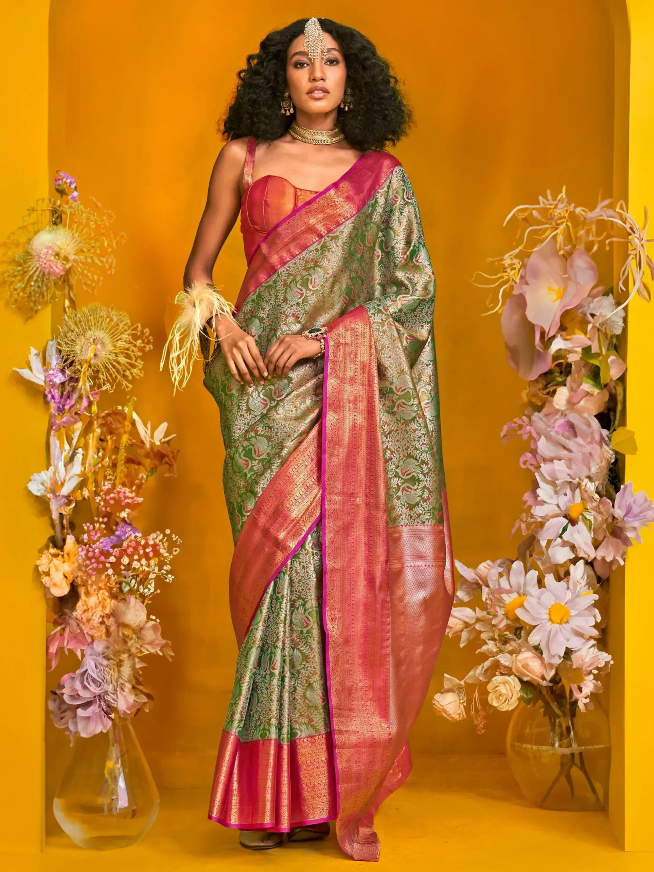 Elegant green and pink designer saree with intricate patterns, perfect for Indian ethnic wear occasions.