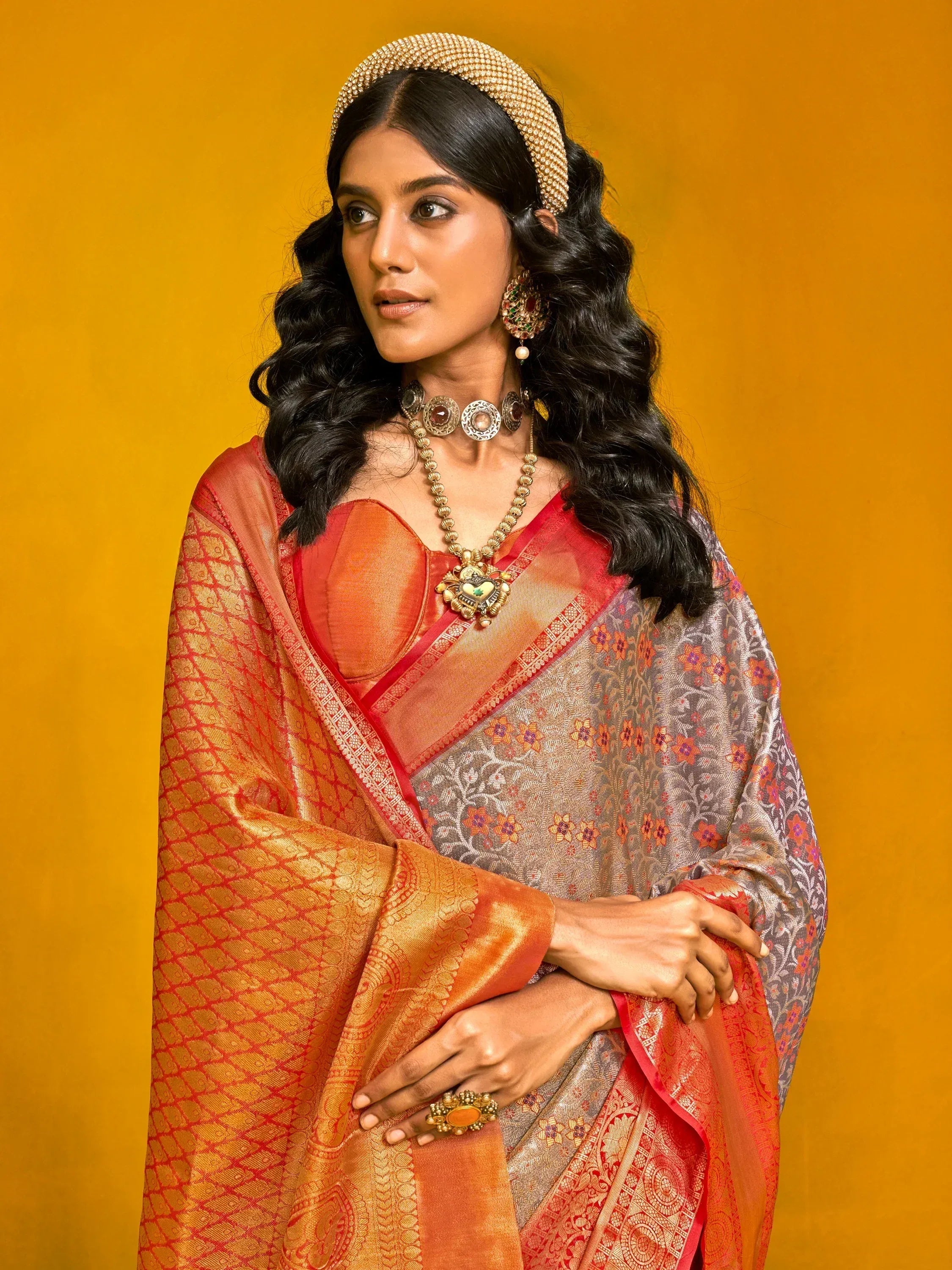 Elegant woman in designer saree with intricate patterns and traditional jewelry, perfect for ethnic wear.