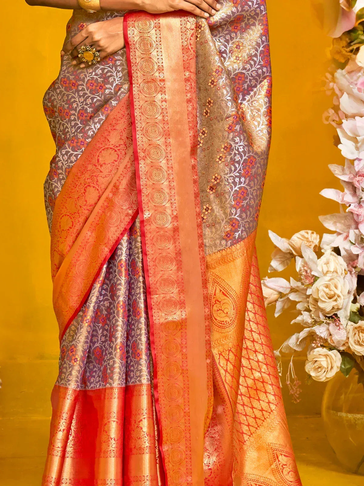 Elegant Indian saree with floral and geometric patterns in orange and purple hues
