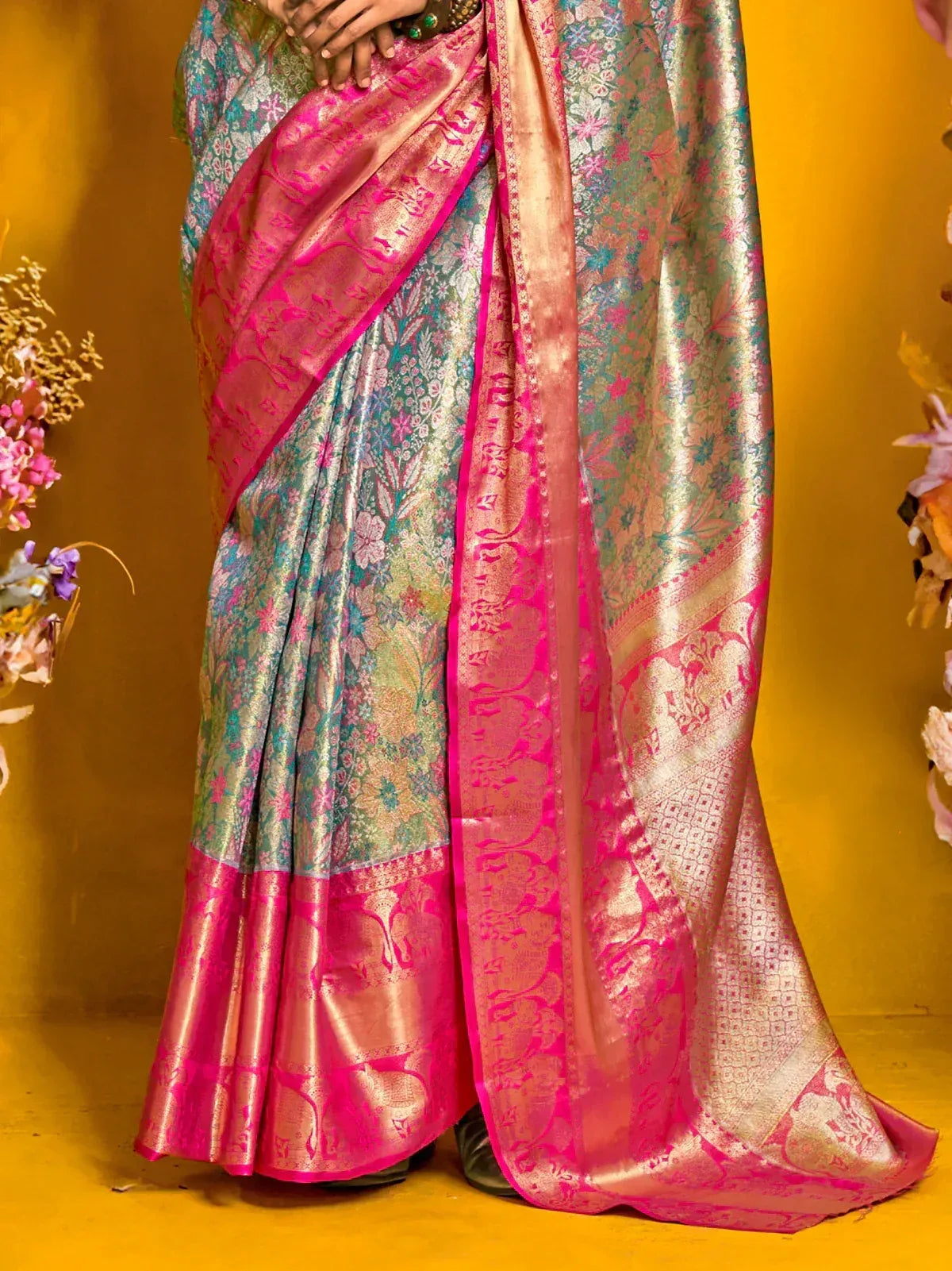 Elegant floral saree with pink border, perfect for Indian ethnic wear occasions.