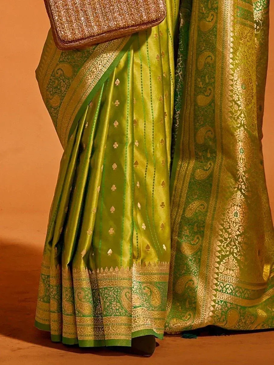Green silk saree with gold paisley border, ethnic Indian wear for festive occasions