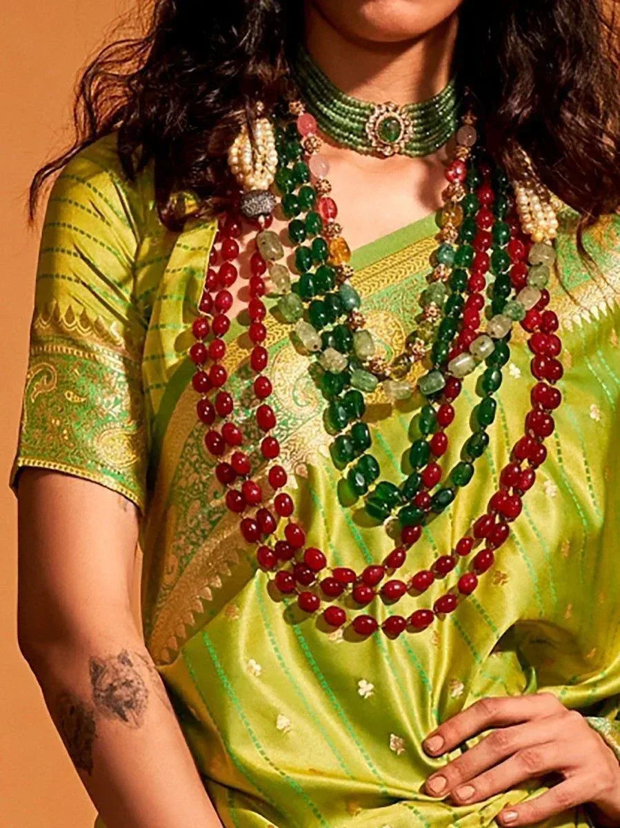 Green ethnic saree with red and green beaded necklace, traditional Indian jewelry