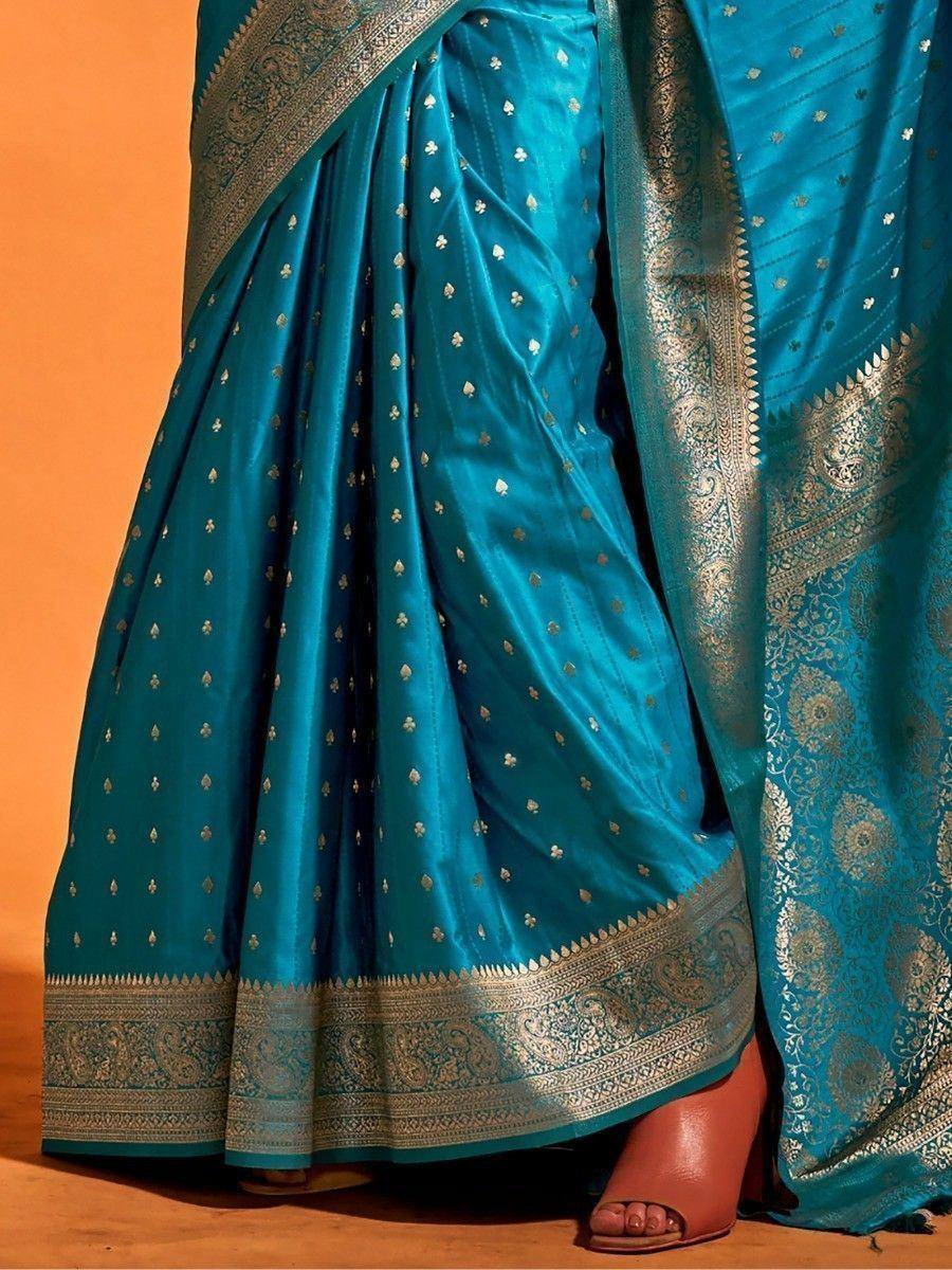 Teal blue silk saree with gold zari border and floral motifs, elegant Indian ethnic wear