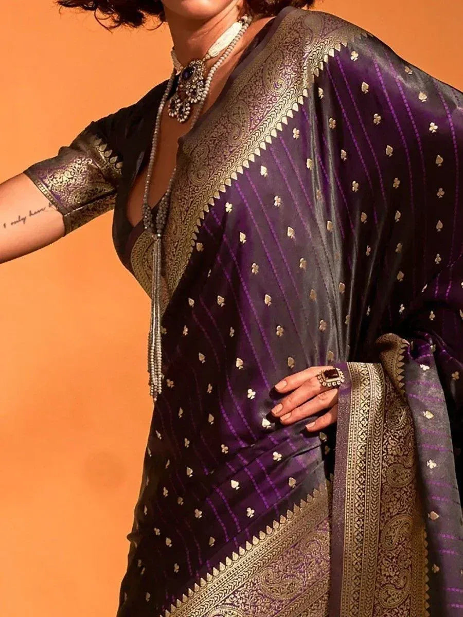 Purple and gold embroidered saree with intricate paisley border, styled with traditional jewelry