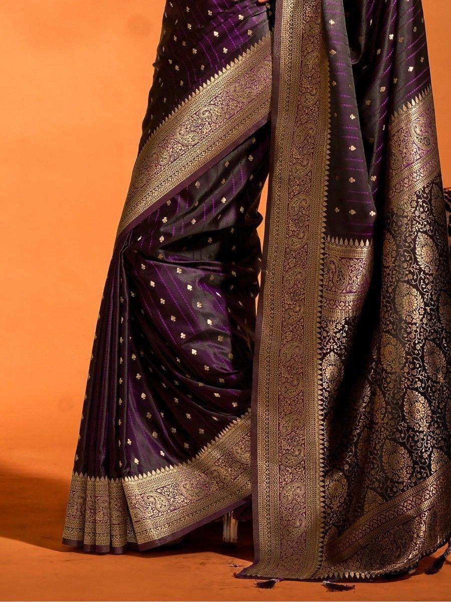 Purple and gold designer saree with intricate zari border and floral motifs, perfect for ethnic occasions.