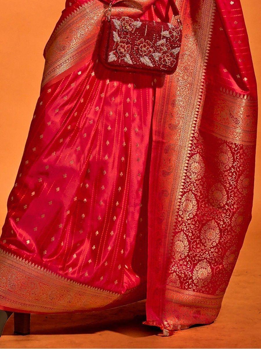 Red silk saree with gold embroidery and matching clutch, perfect for ethnic occasions
