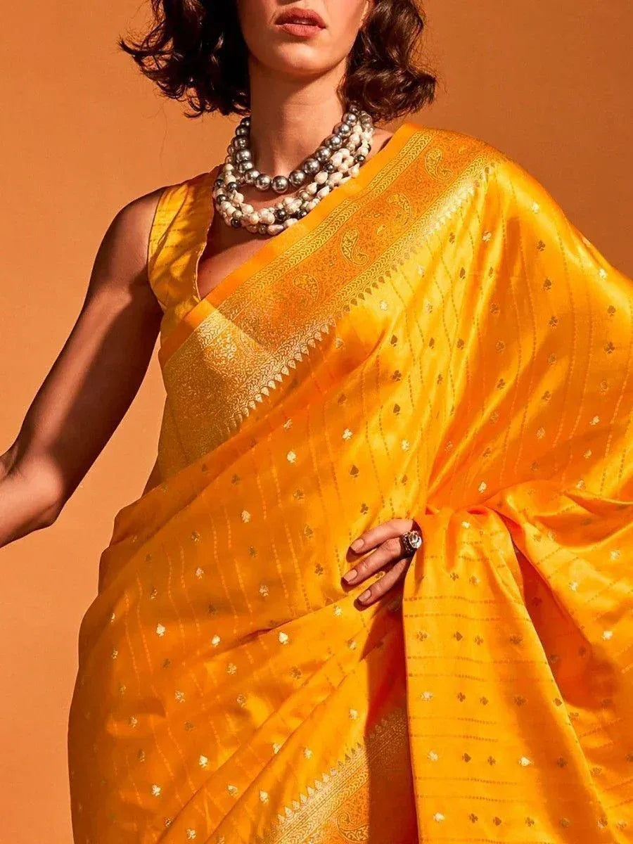 Vibrant yellow silk saree with gold zari work, perfect for Indian ethnic occasions and festive wear.