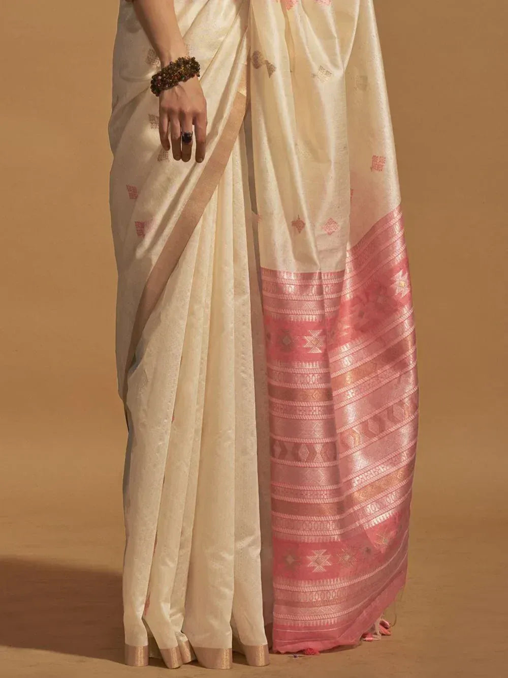Cream saree with pink border and geometric motifs, elegant Indian ethnic wear