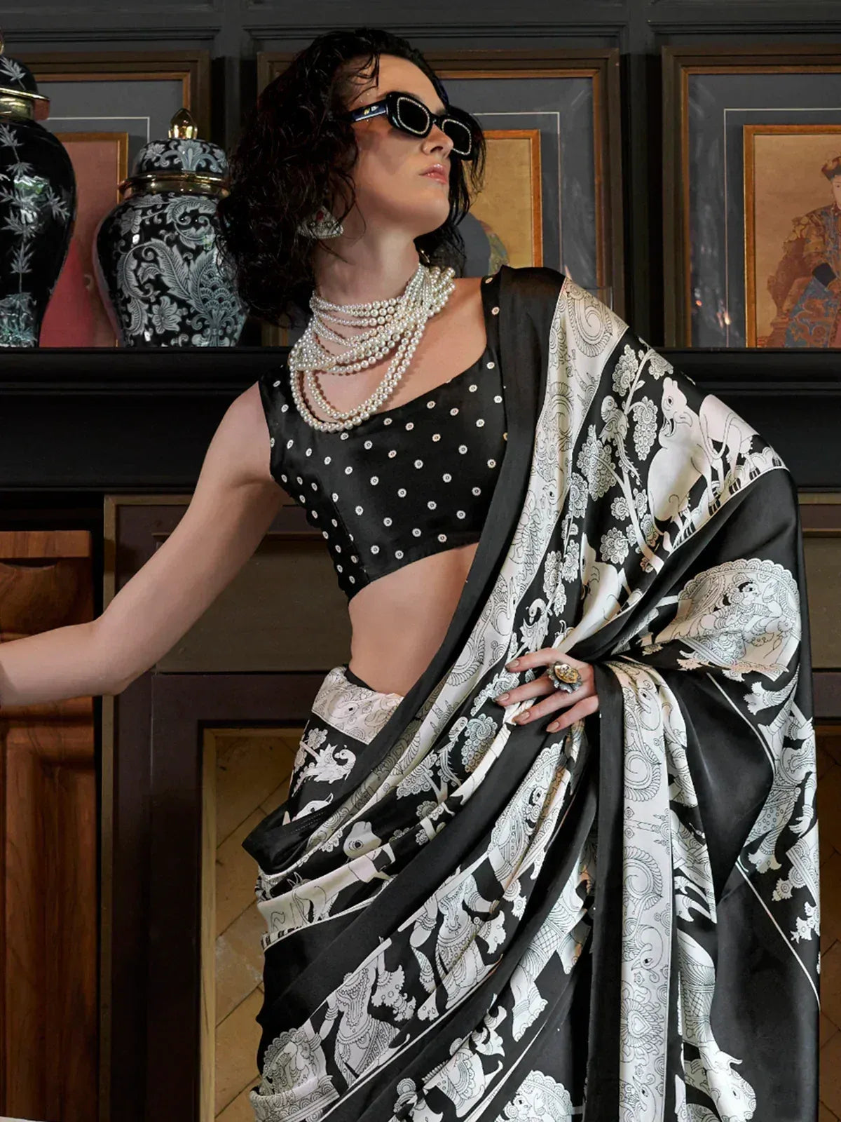 Black and white printed saree with polka dot blouse, styled with pearl necklaces and sunglasses