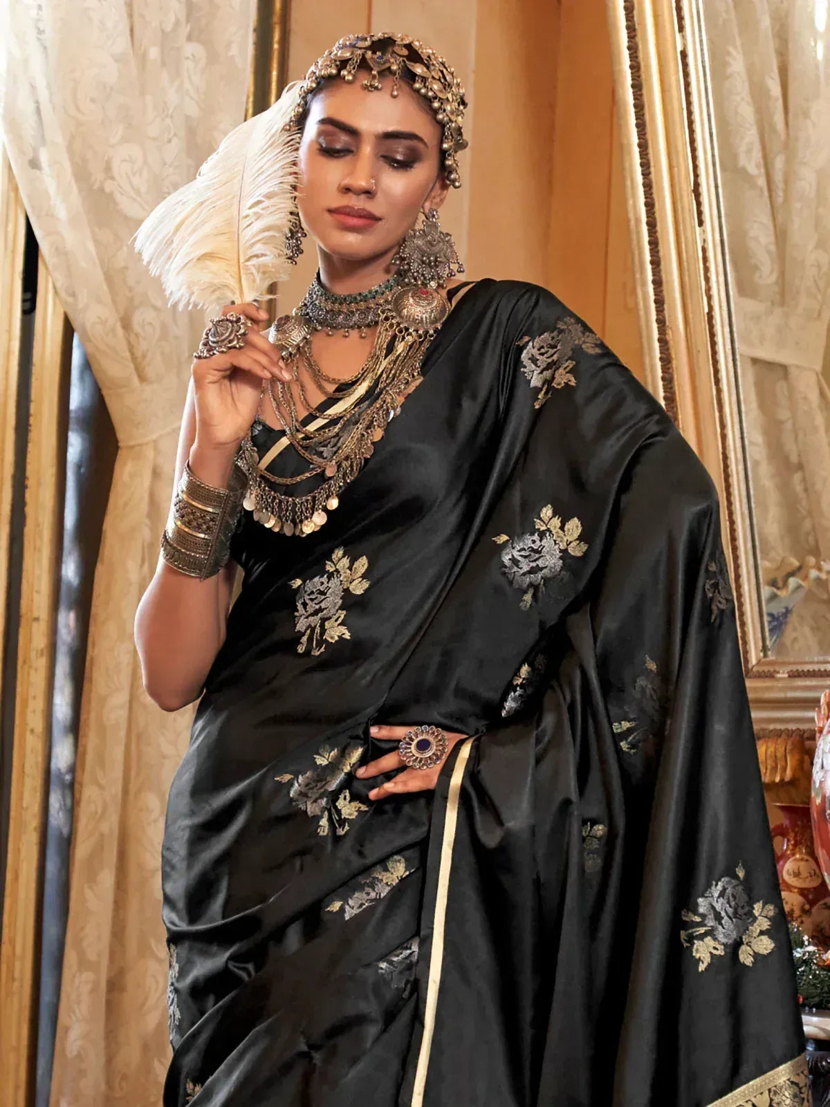Elegant black silk saree with gold floral embroidery, styled with traditional Indian jewelry for festive occasions.