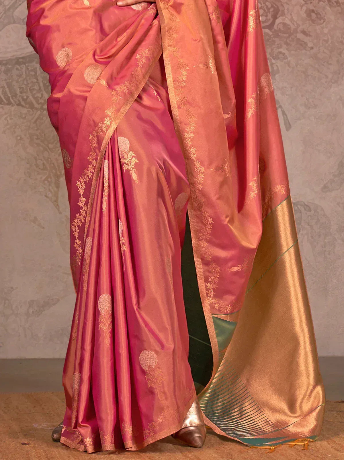 Pink and gold designer saree with floral zari border, perfect for ethnic occasions