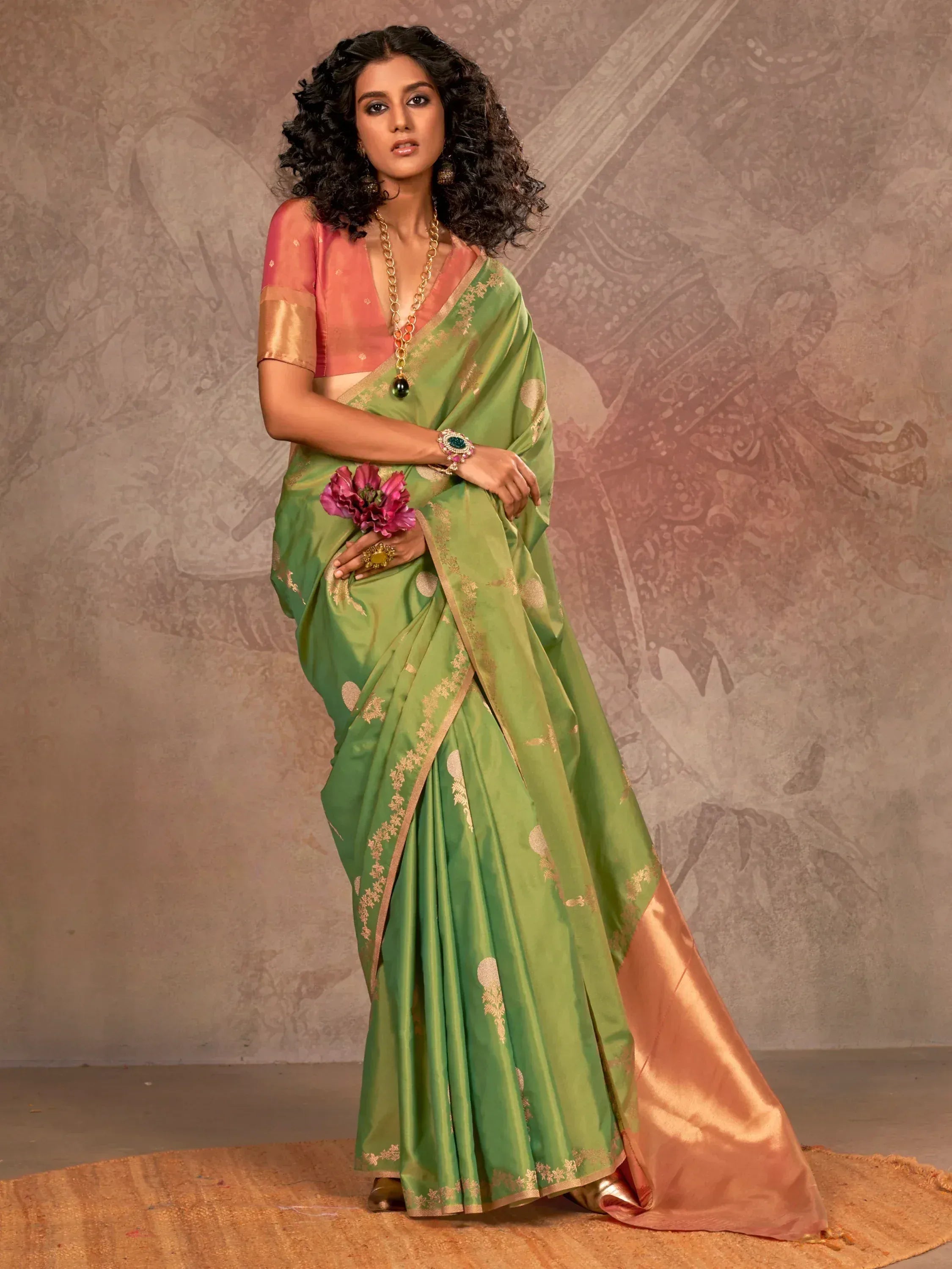 Green and peach designer saree with gold embroidery, paired with matching blouse for Indian ethnic wear.