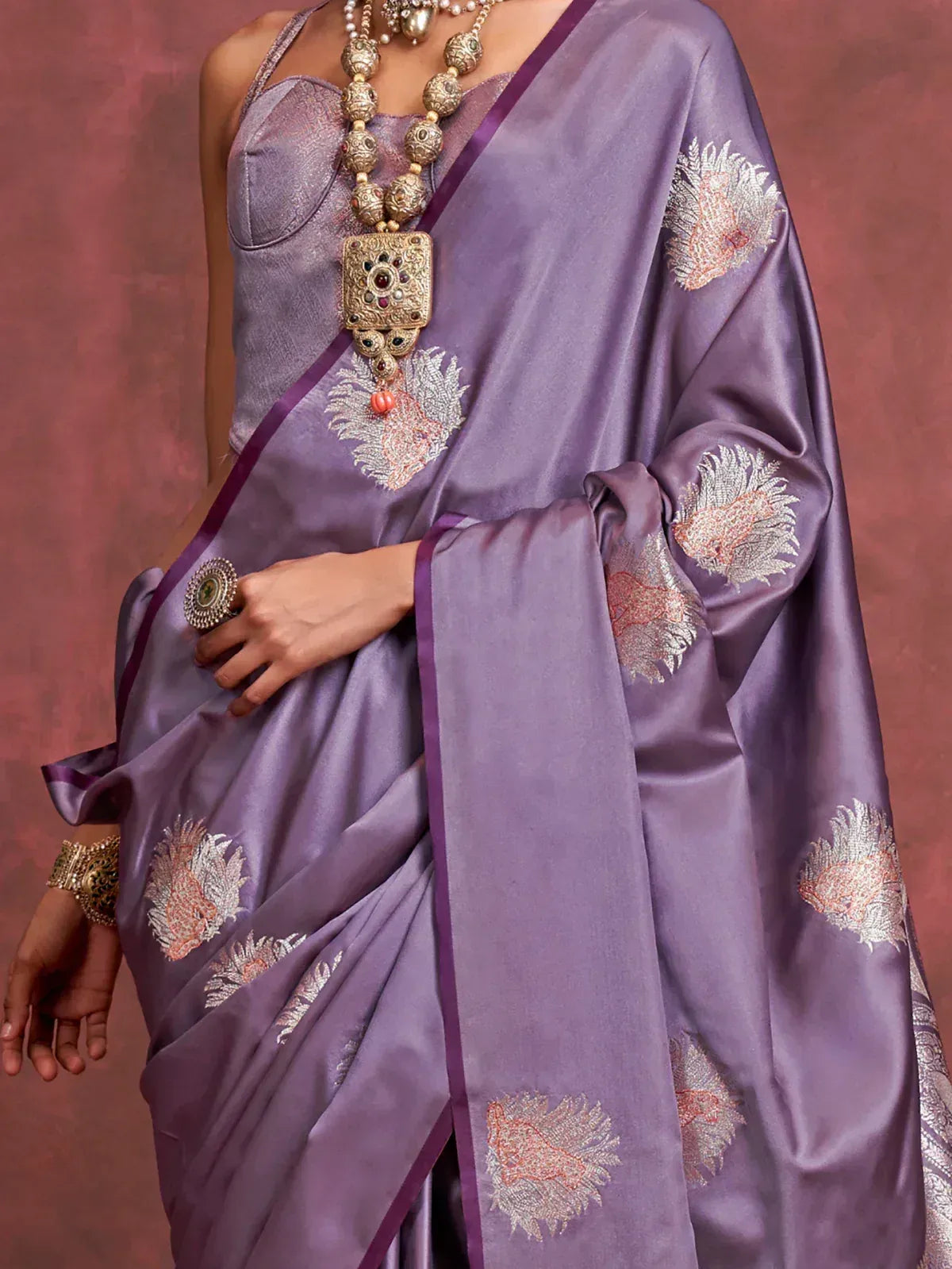 Purple silk saree with floral embroidery, paired with traditional jewelry for ethnic wear