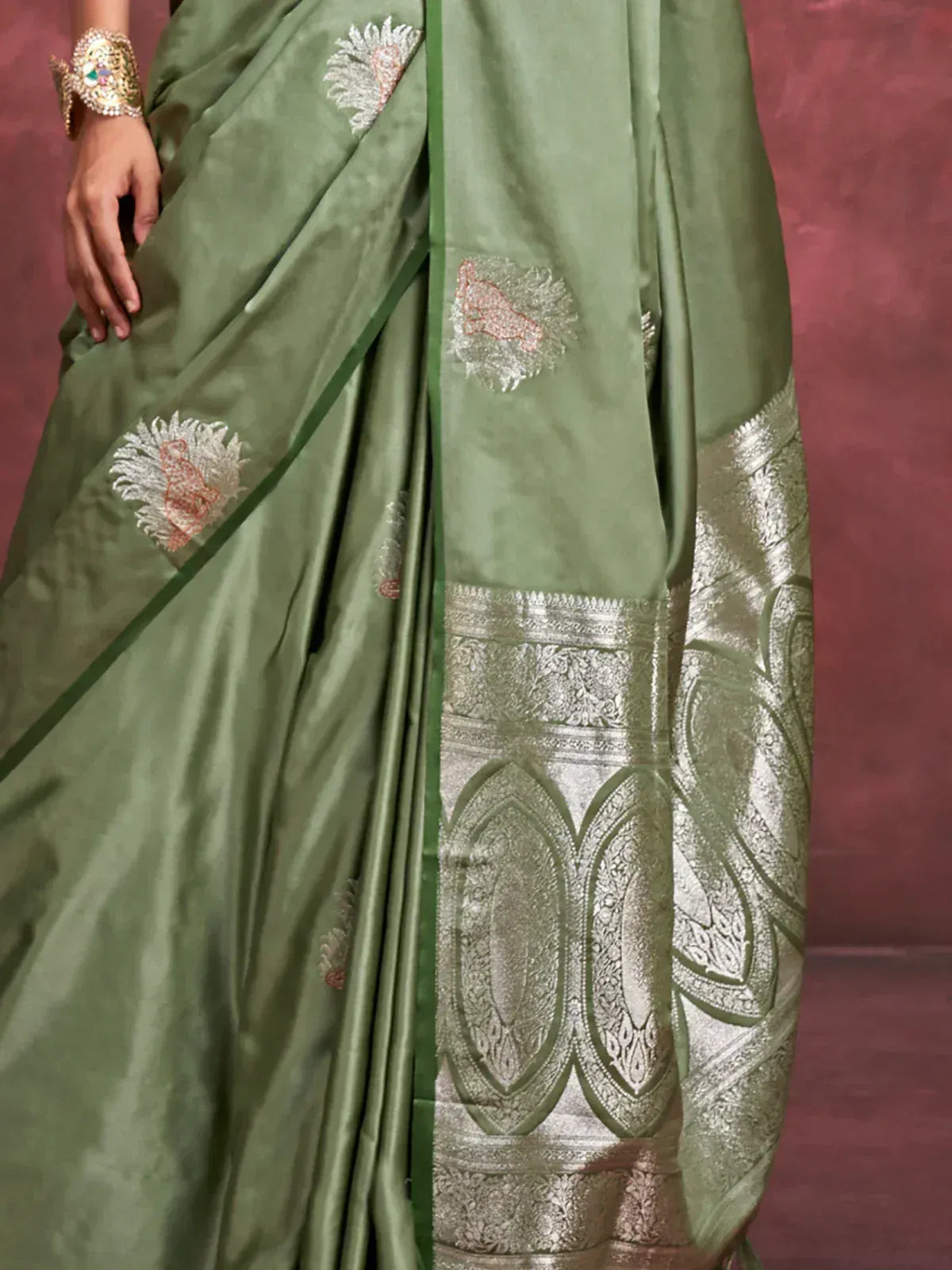 Olive green saree with floral embroidery and intricate silver border design