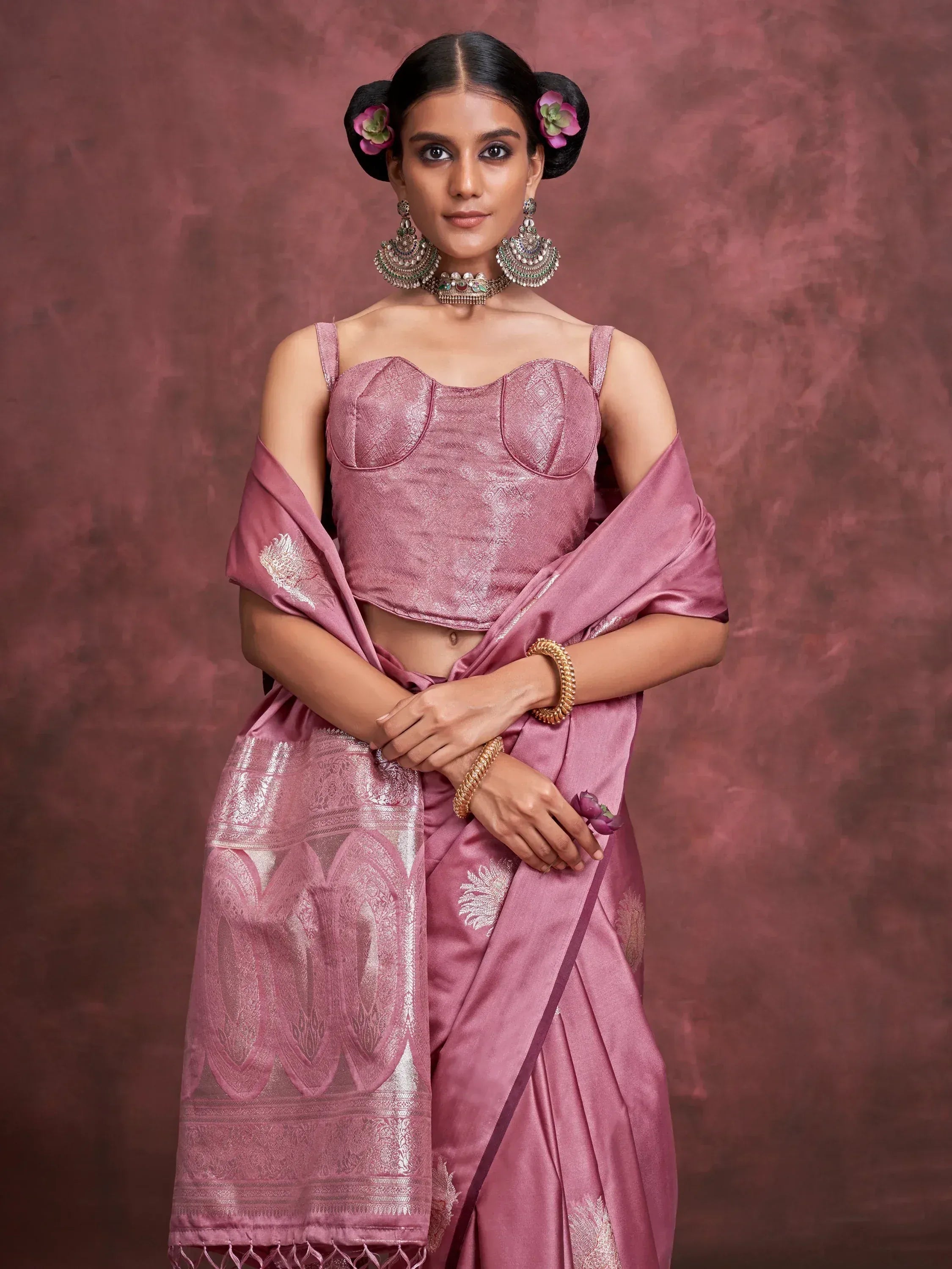 Pink designer saree with embroidered blouse, traditional jewelry, and floral hair accessories for Indian ethnic wear