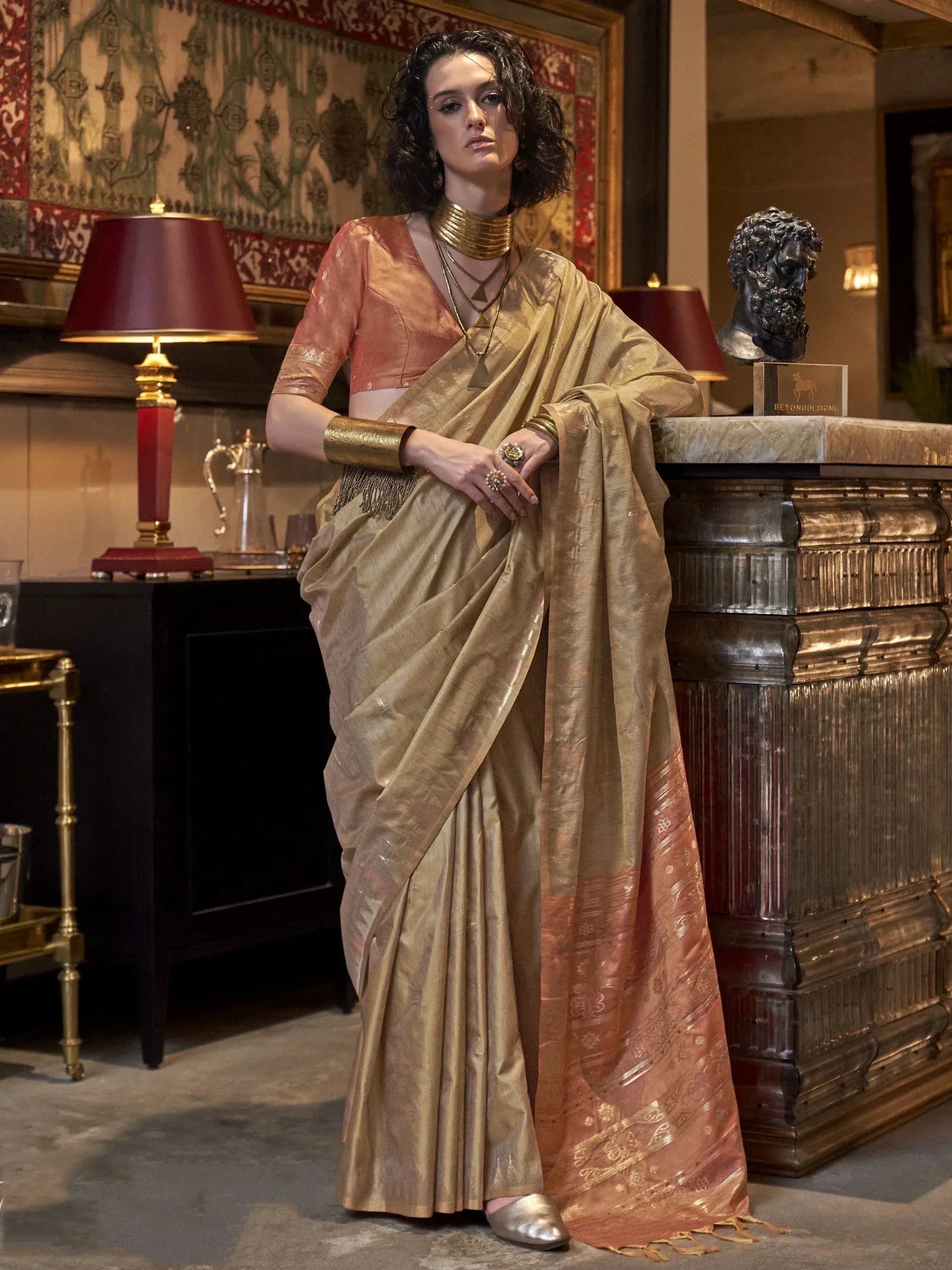 Elegant gold and peach designer saree with matching blouse, perfect for Indian ethnic wear occasions.