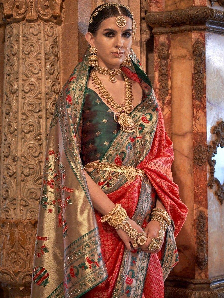 Elegant Indian bride in red and green embroidered saree with gold jewelry, traditional ethnic wear