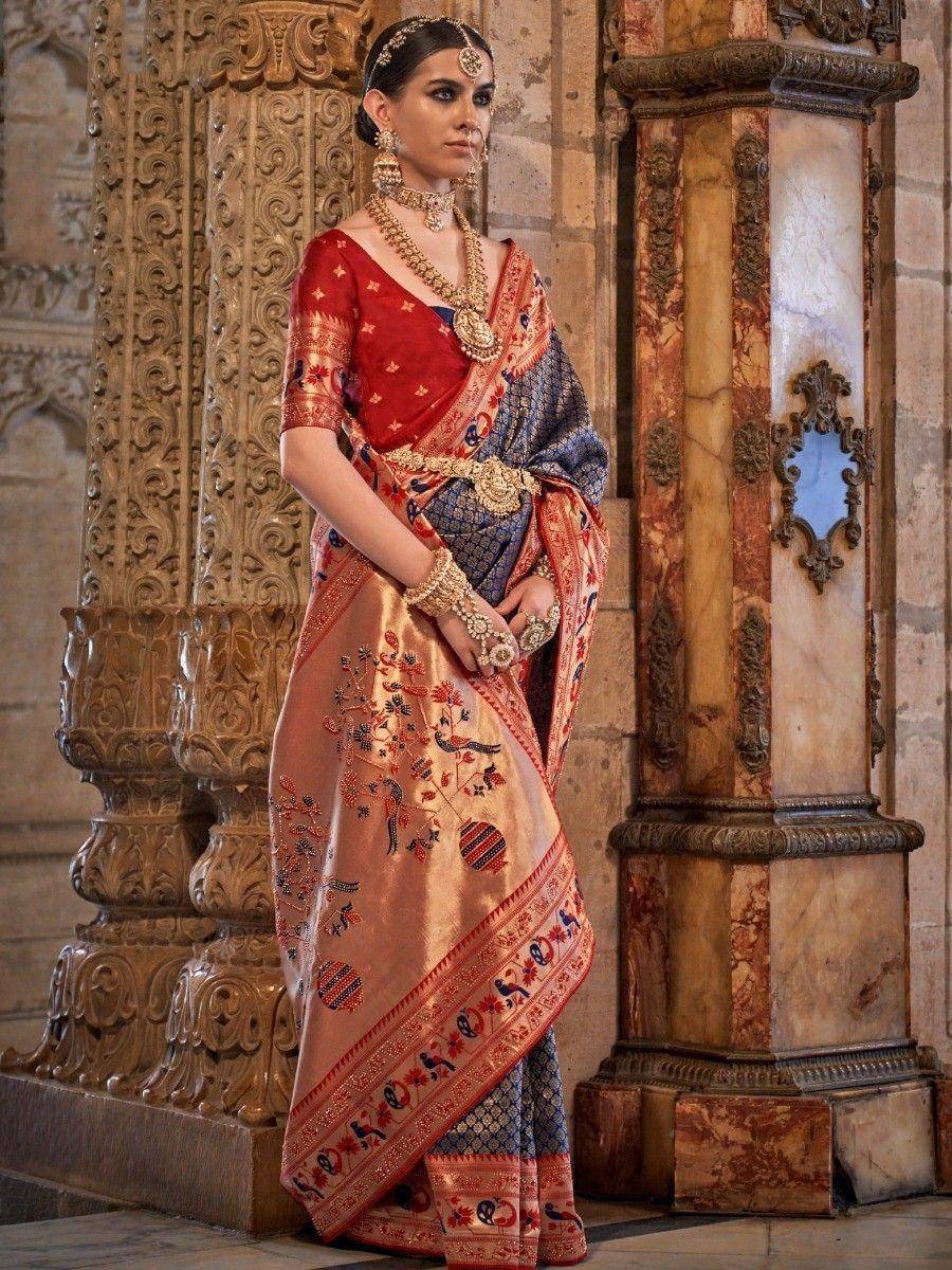 Elegant Indian saree with peacock embroidery, red blouse, and gold jewelry, styled for festive occasions.