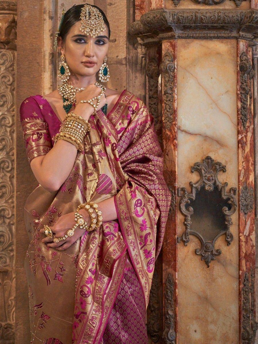 Elegant woman in pink and gold designer saree with intricate embroidery and traditional Indian jewelry