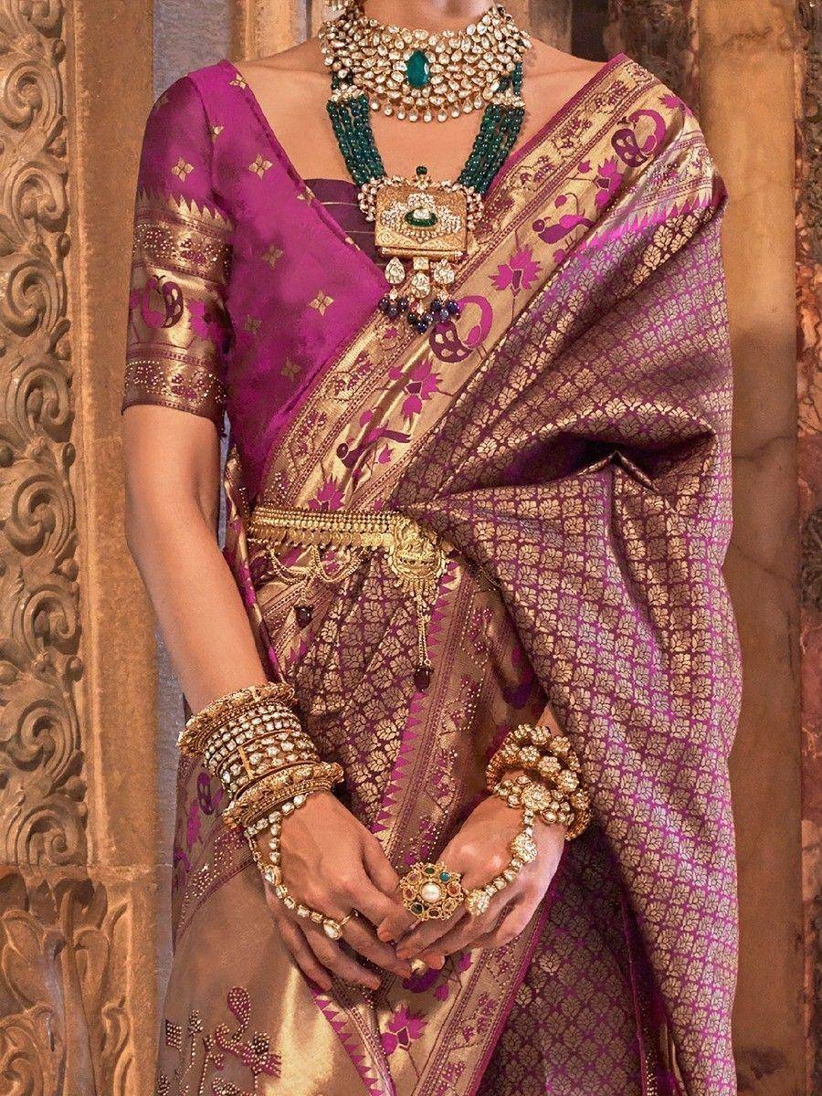 Purple and gold designer saree with intricate embroidery, paired with traditional Indian jewelry for ethnic wear.