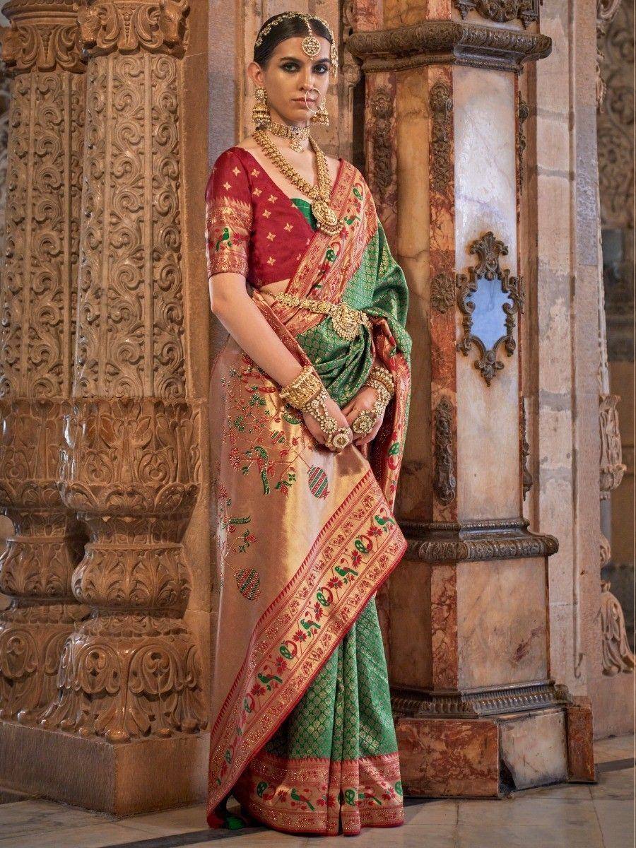 Elegant green and red embroidered saree with gold jewelry, perfect for Indian ethnic occasions