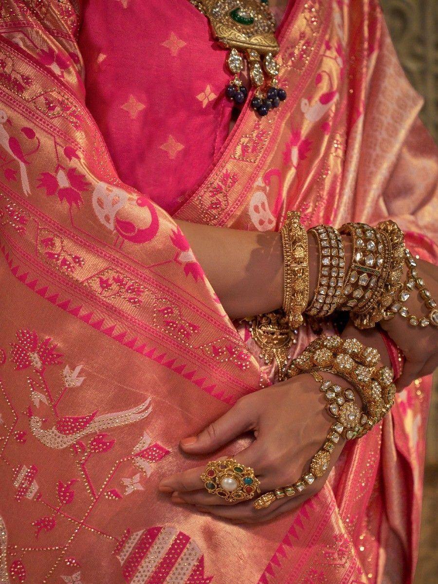 Pink embroidered saree with gold jewelry, perfect for Indian ethnic wear occasions