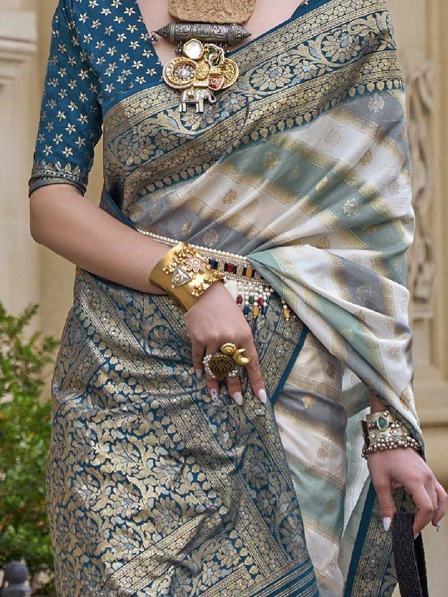 Elegant blue and gold designer saree with intricate embroidery, paired with traditional Indian jewelry for festive occasions.