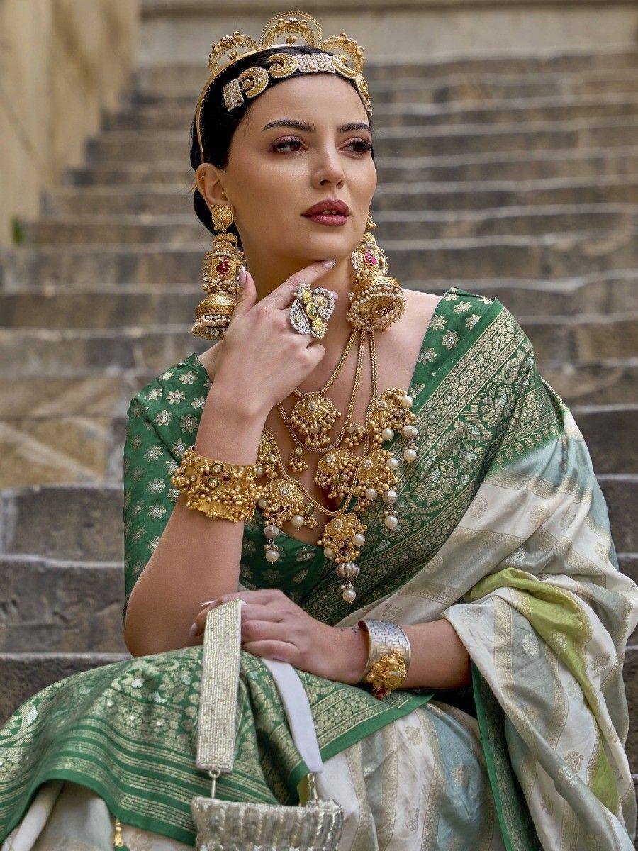 Elegant woman in green and gold Indian saree with traditional temple jewelry, perfect for ethnic occasions.
