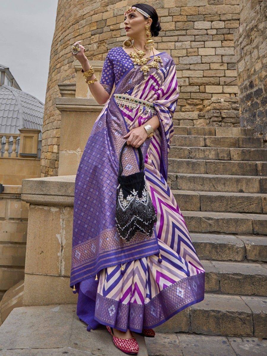 Purple and white chevron patterned ethnic saree with gold jewelry, styled for festive occasions