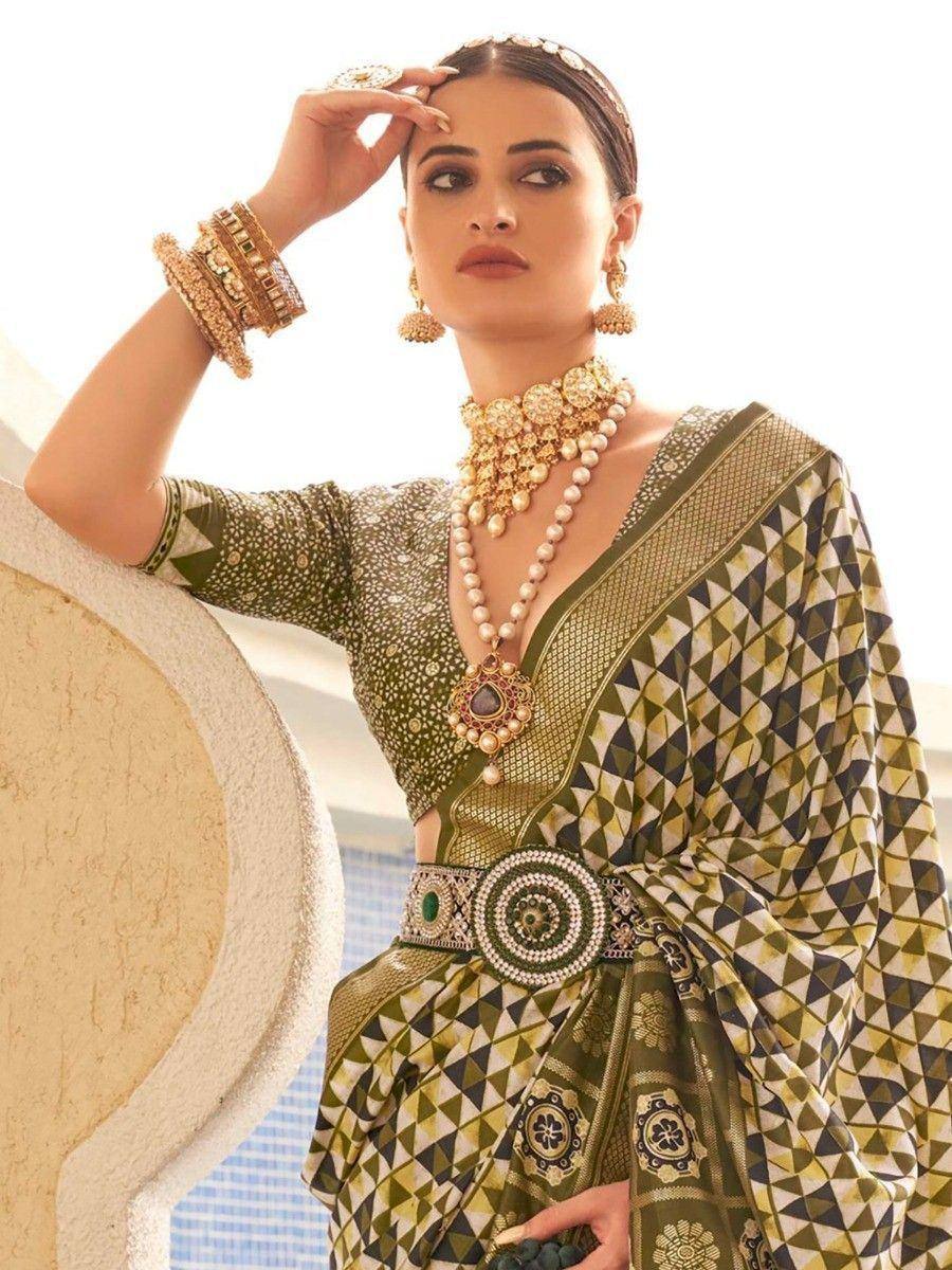 Elegant green printed saree with gold jewelry, perfect for Indian ethnic occasions and weddings.