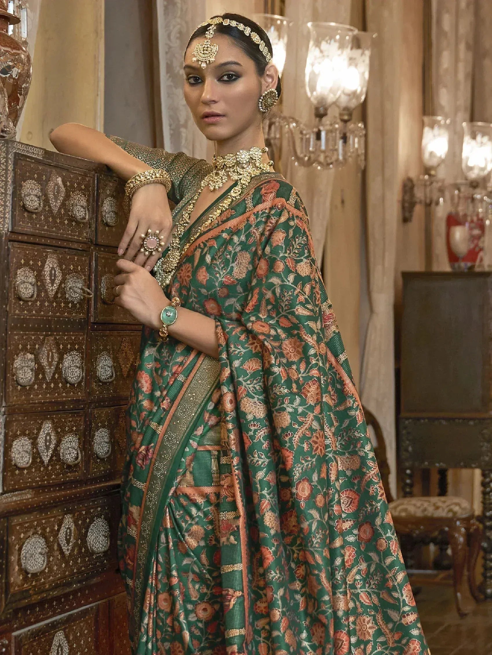Elegant green floral saree with gold jewelry, perfect for Indian ethnic wear and festive occasions.
