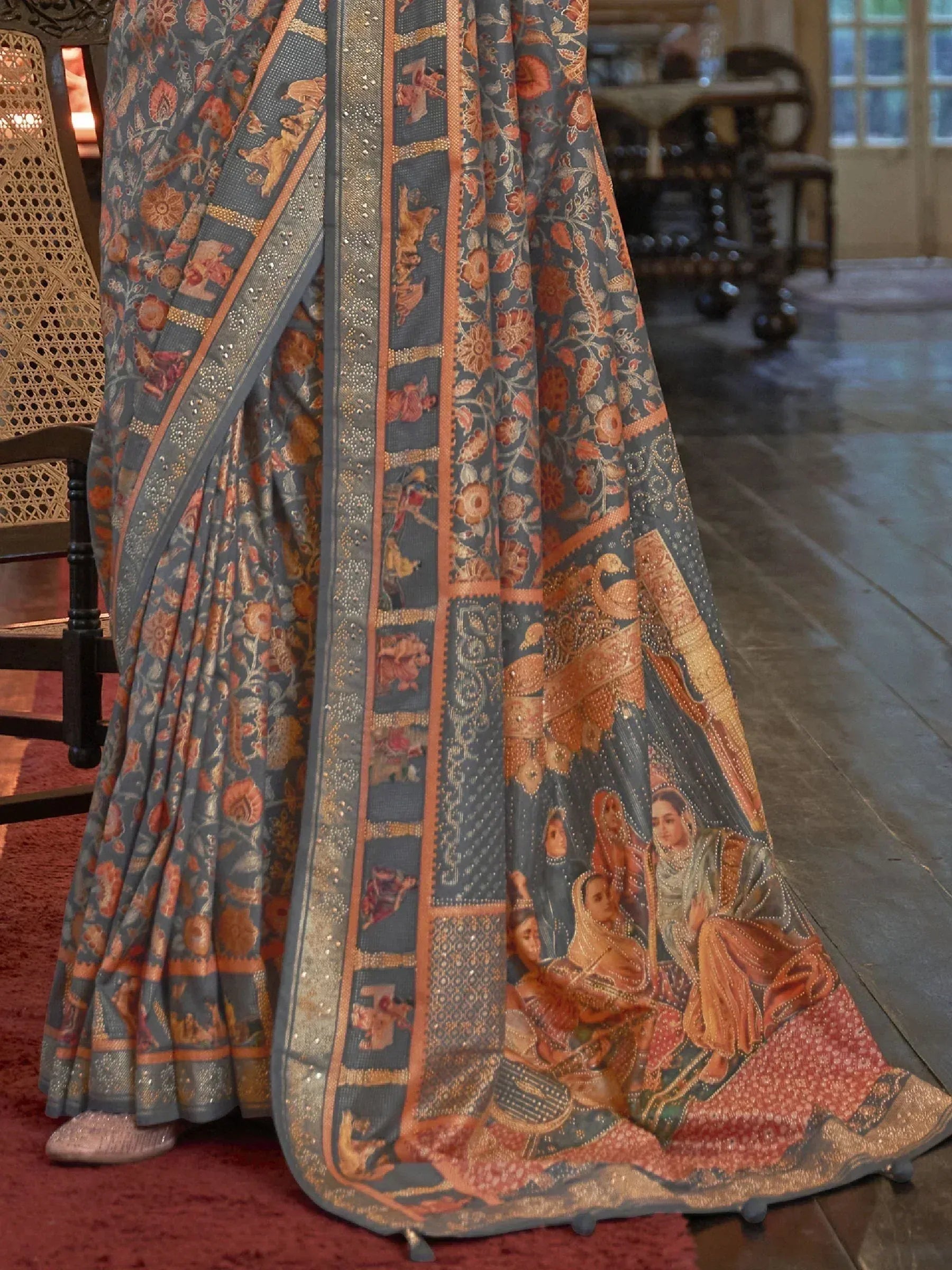 Grey and orange floral printed saree with intricate temple border and embroidered motifs, ideal for Indian ethnic wear.