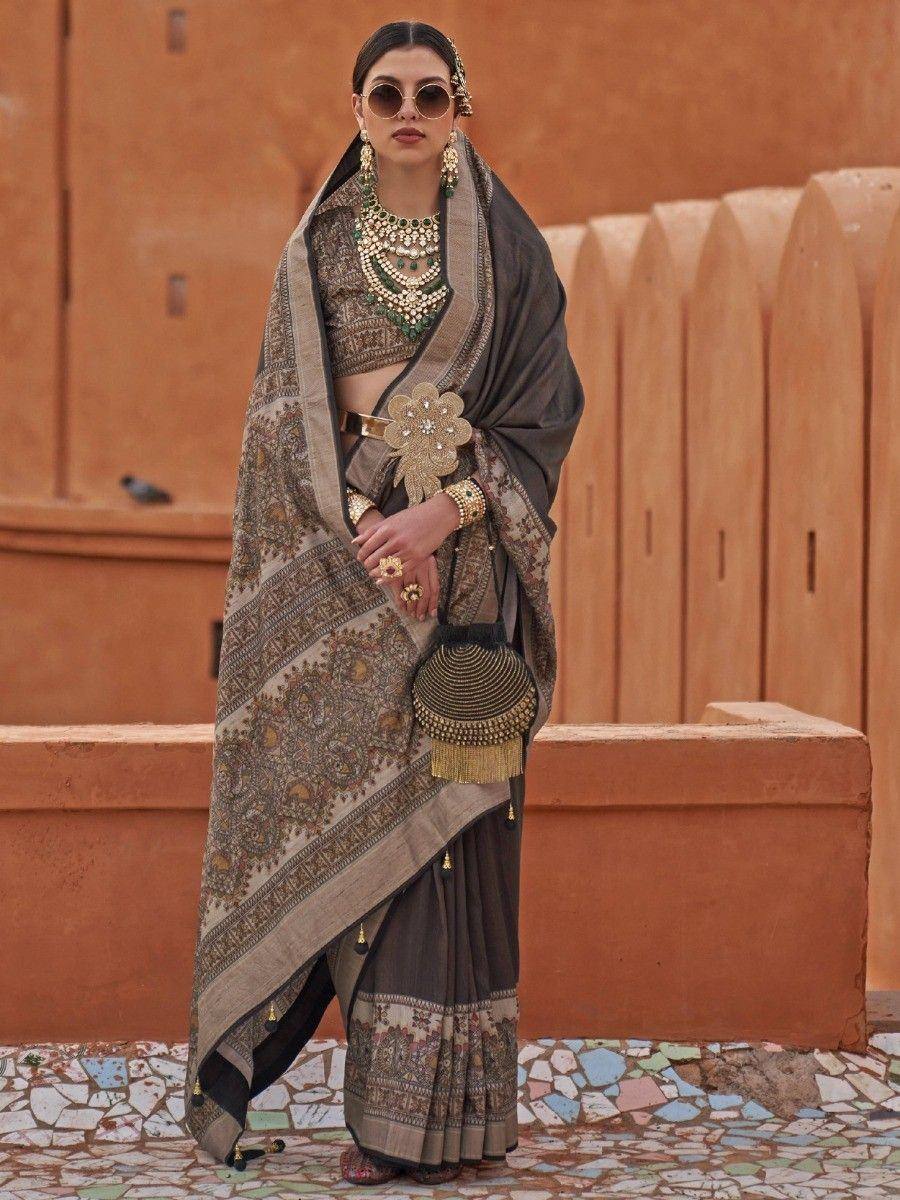 Elegant Indian ethnic saree with intricate embroidery, paired with statement jewelry and a designer blouse.