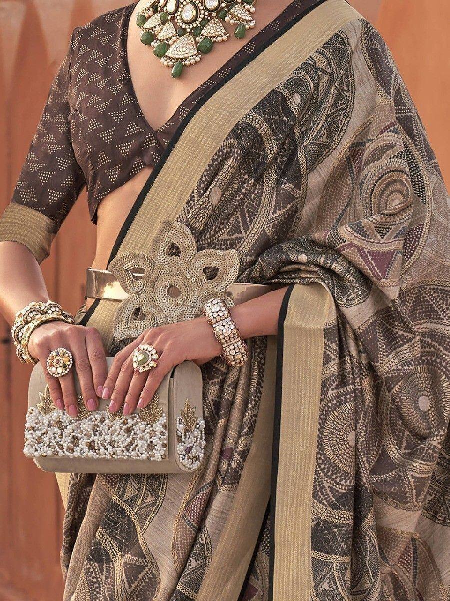 Elegant brown and gold printed saree with matching blouse, statement jewelry, and beaded clutch for ethnic occasions