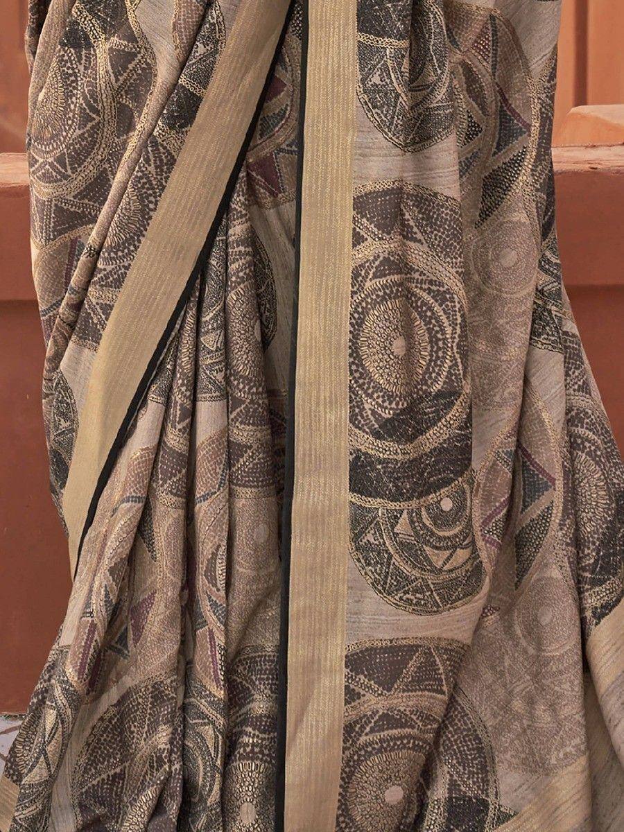 Elegant ethnic saree with intricate geometric print and gold border, perfect for traditional occasions.