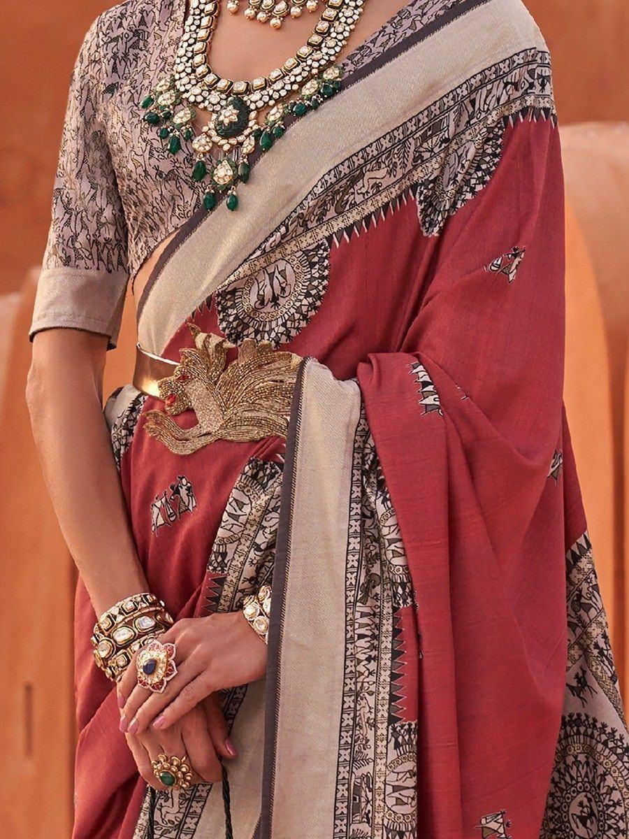 Red printed saree with gold embroidery, ethnic jewelry, and designer blouse for Indian occasions
