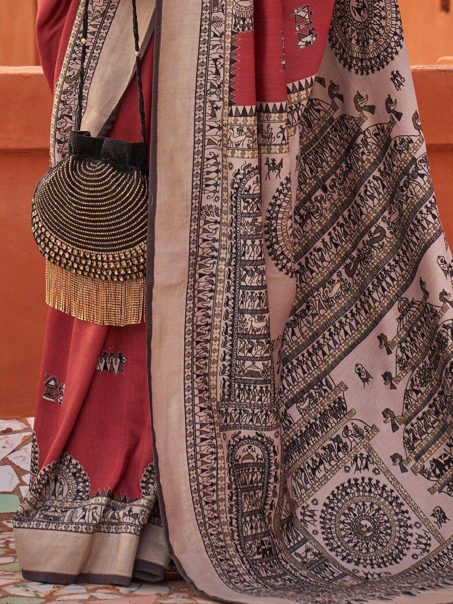 Ethnic saree with tribal print, red blouse, and beaded handbag for traditional Indian wear