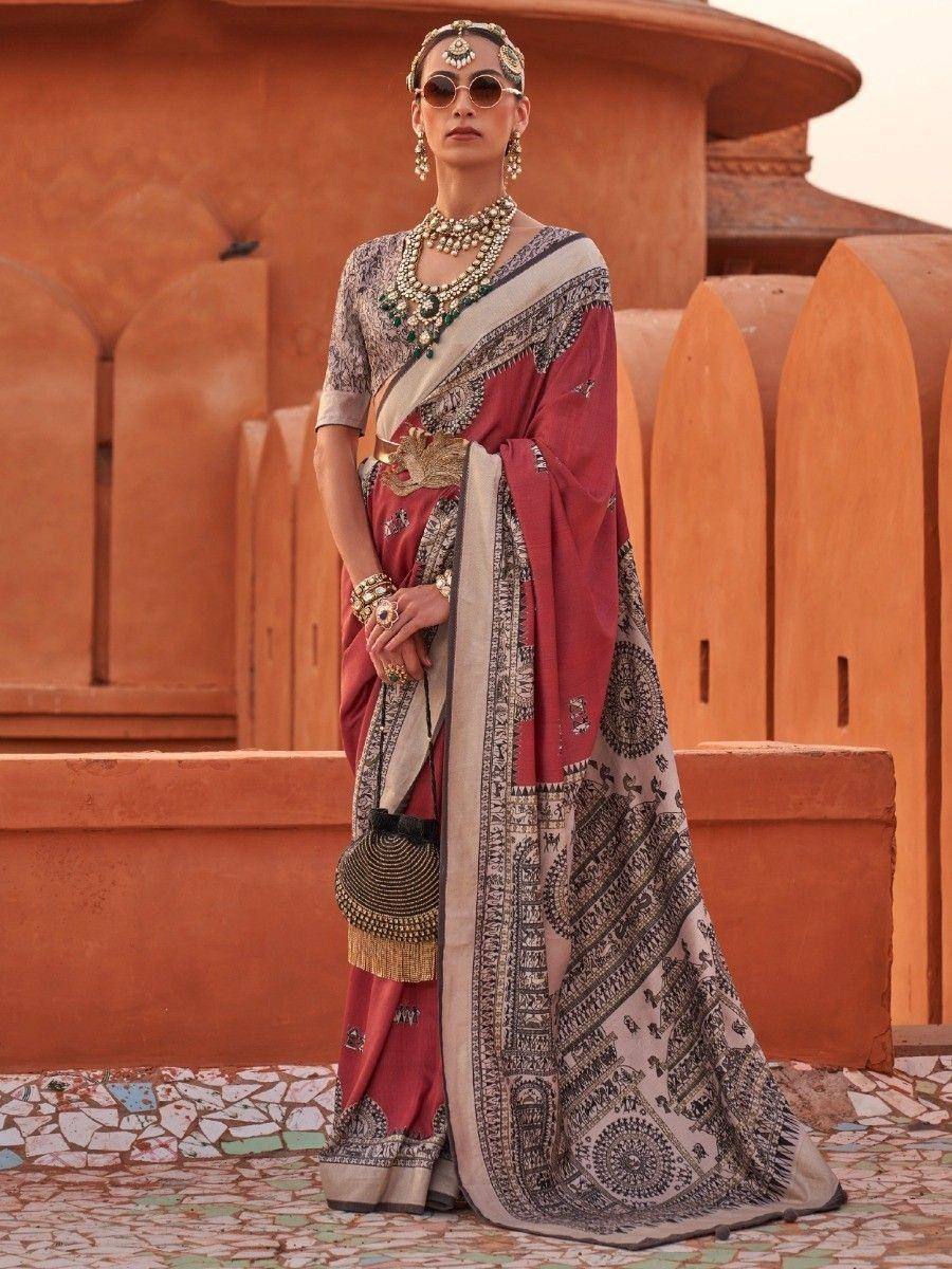 Woman in elegant red and beige printed saree with traditional jewelry, perfect for ethnic occasions
