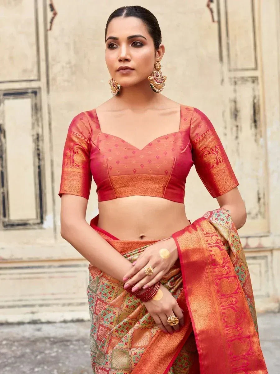Woman in vibrant red and gold designer saree with embroidered blouse, traditional Indian ethnic wear