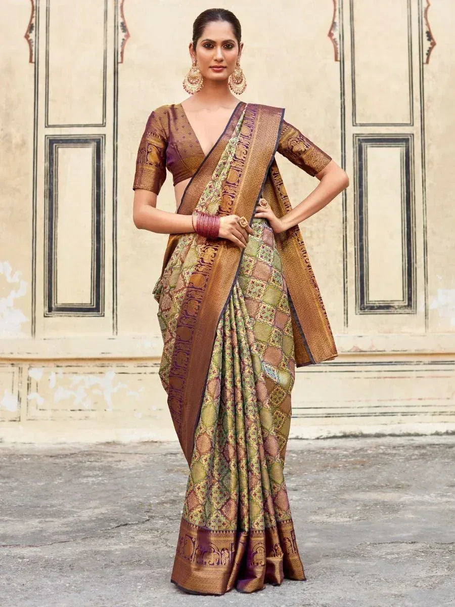 Elegant Indian saree with intricate gold and green patterns, paired with matching blouse and traditional jewelry.
