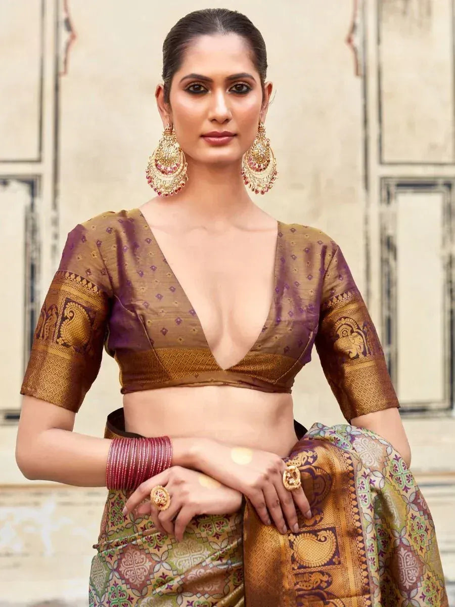 Elegant Indian saree with gold and purple blouse, traditional jewelry, perfect for festive occasions