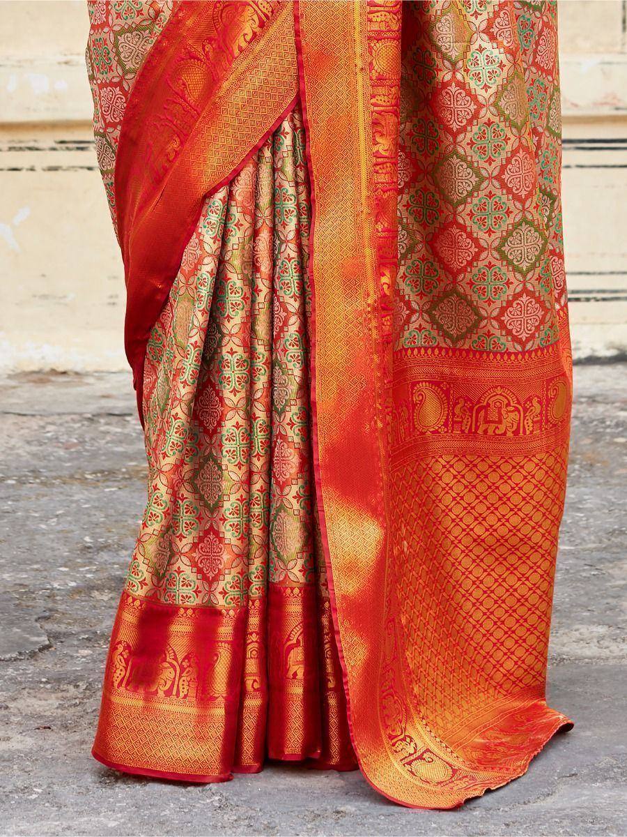 Red and gold designer saree with intricate floral and elephant motifs, perfect for ethnic occasions
