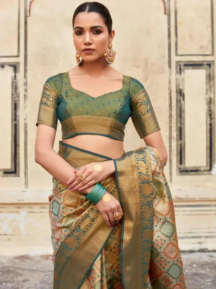 Woman in elegant green and gold printed saree with matching blouse, traditional Indian ethnic wear