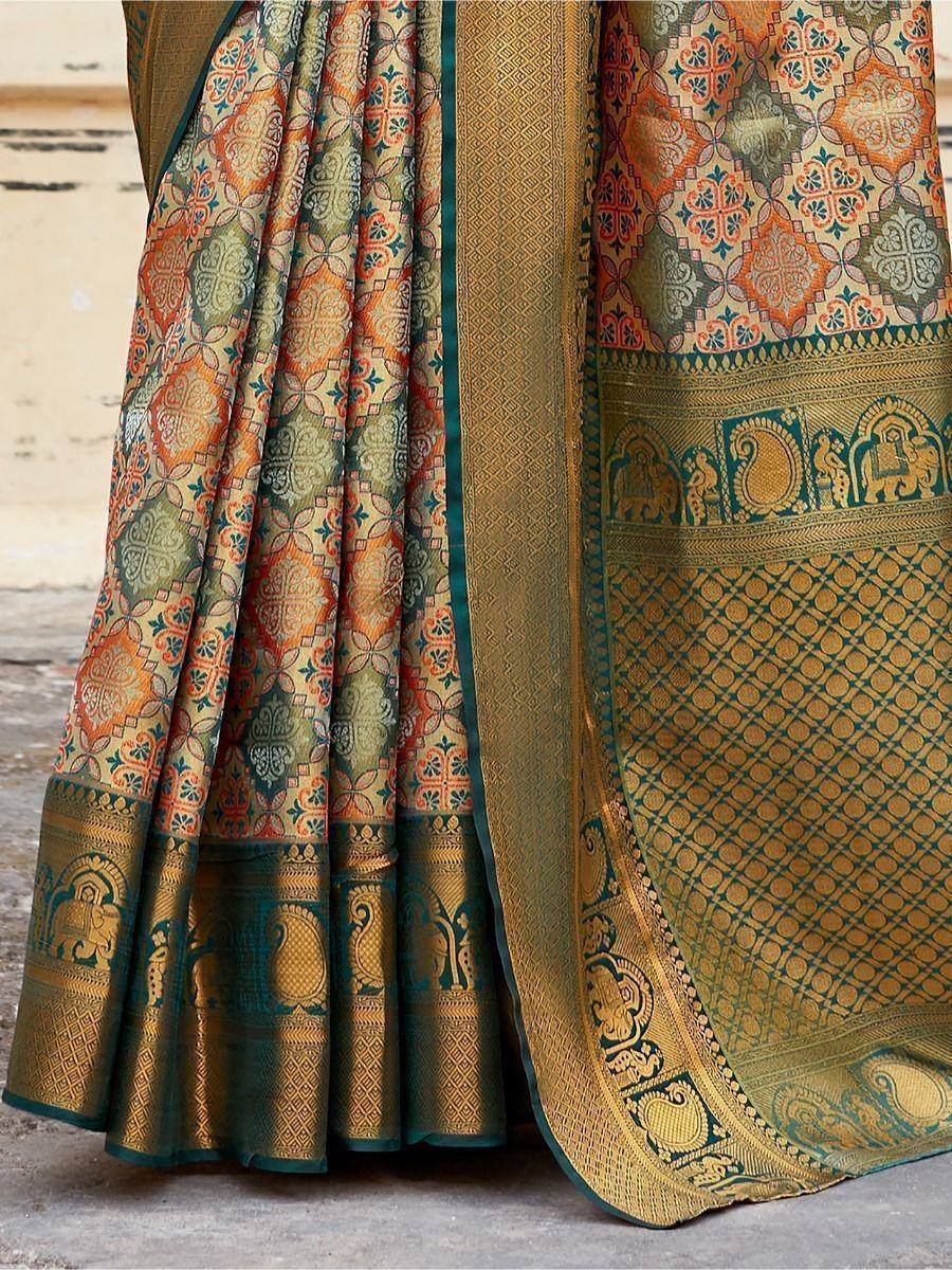 Elegant Indian saree with intricate floral and elephant motifs in gold, green, and orange tones