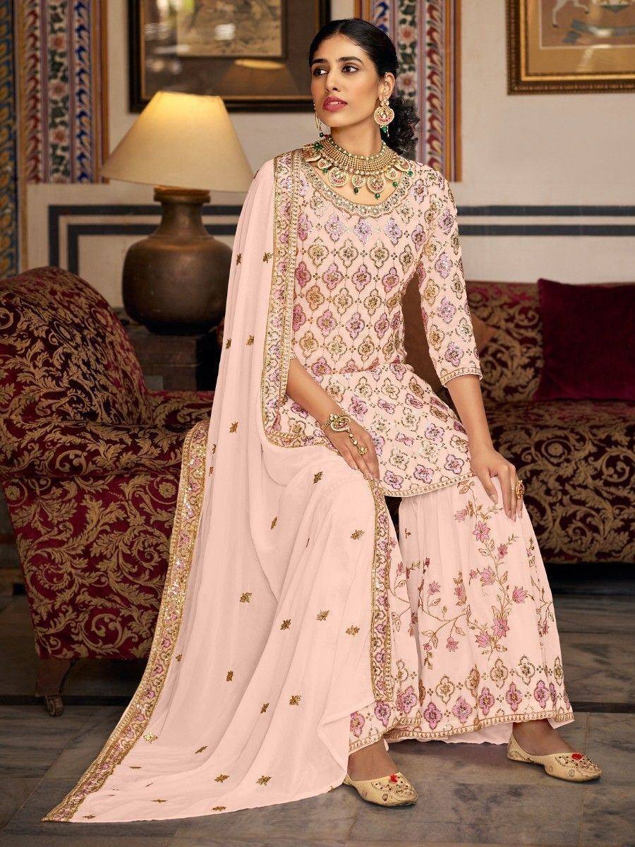 Elegant pink embroidered sharara suit with gold detailing, perfect for Indian ethnic occasions