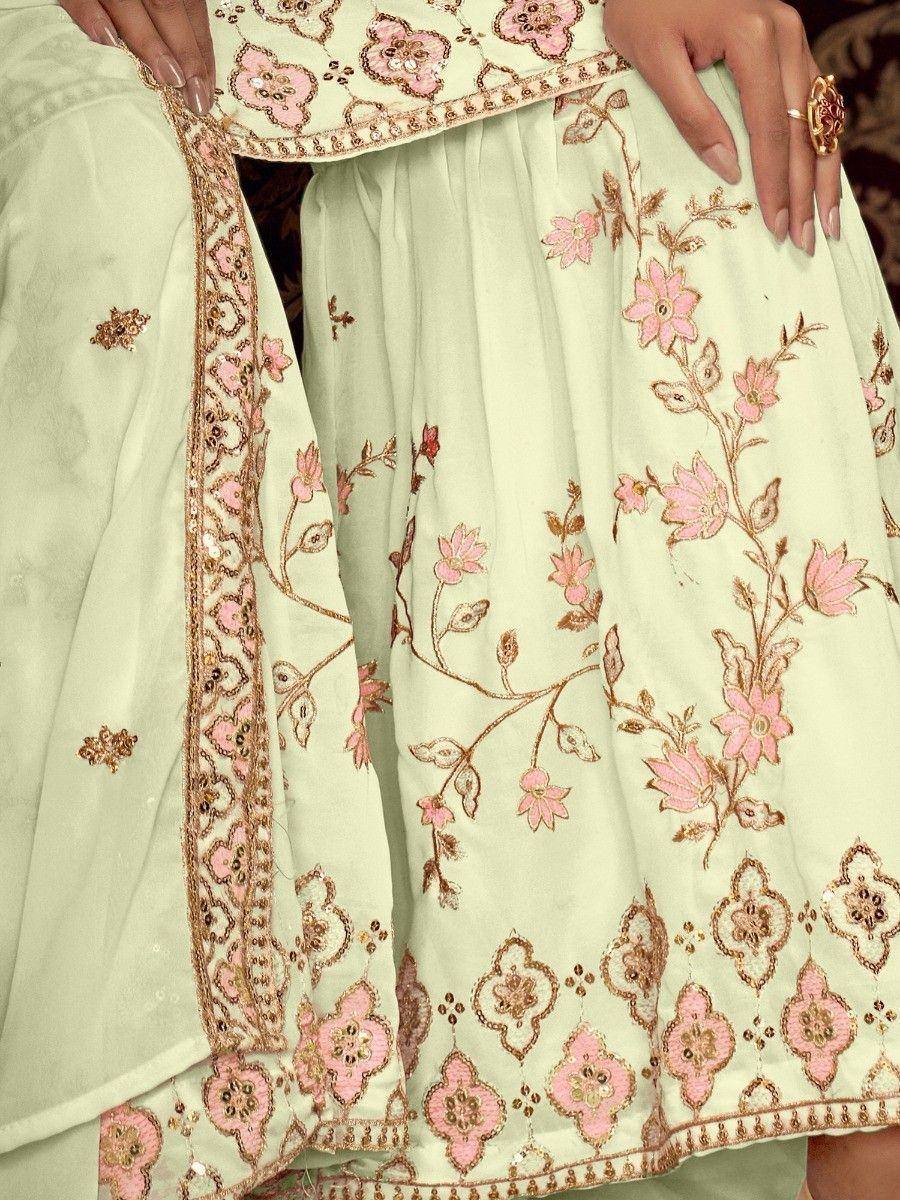 Mint green ethnic salwar kameez with pink floral embroidery and gold detailing, perfect for festive occasions.