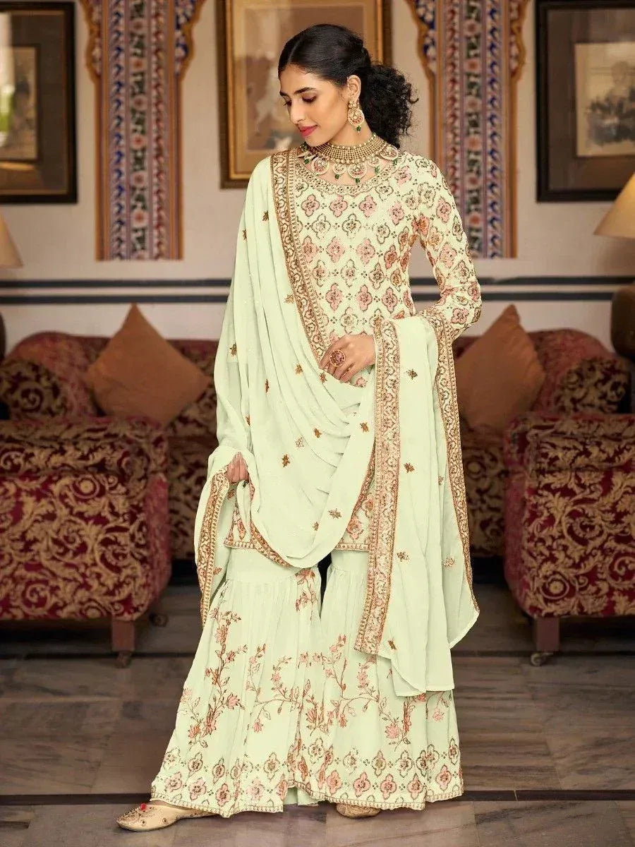 Mint green embroidered salwar kameez with floral motifs and gold border, perfect for Indian ethnic occasions