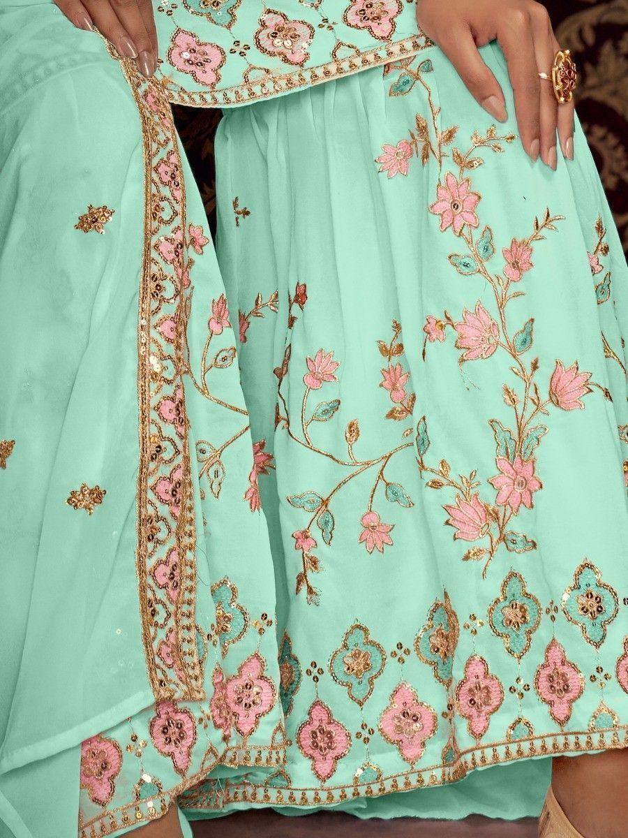 Mint green ethnic salwar kameez with pink floral embroidery and gold detailing, perfect for festive occasions.